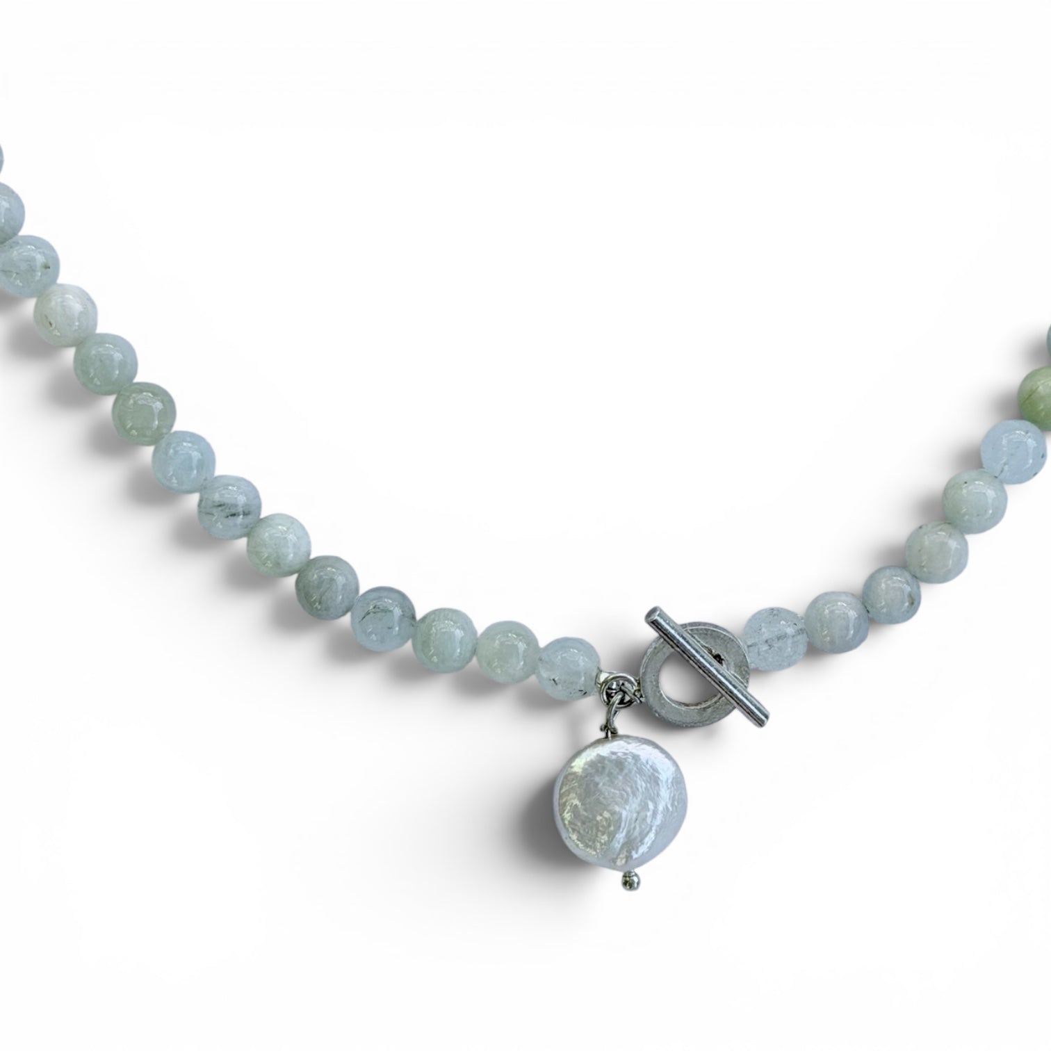 Close-up of the Neptune freshwater coin pearl and aquamarine sterling silver necklace